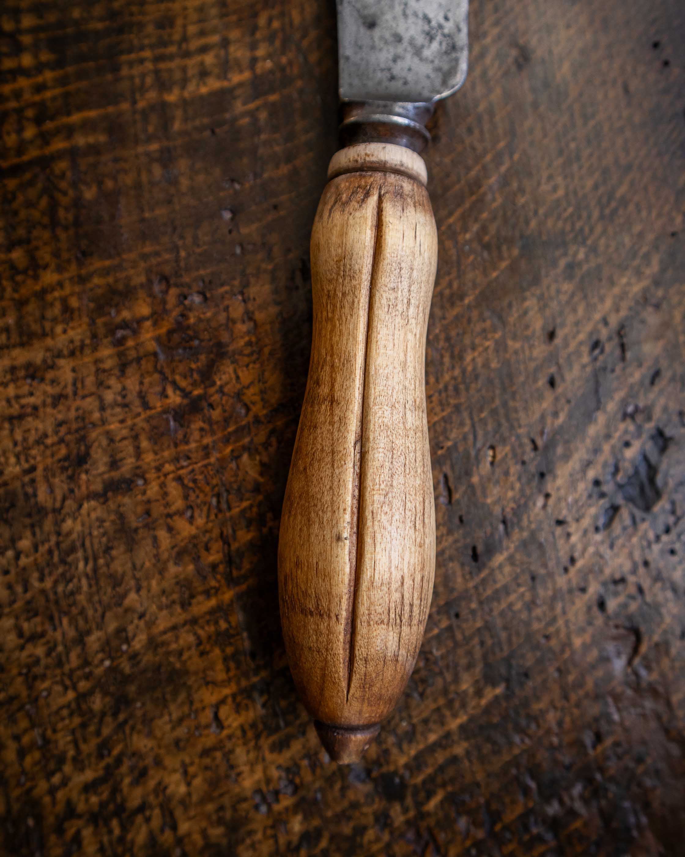 Wooden-handled knife on a wooden surface