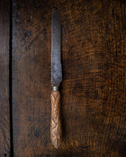 Antique knife with a wooden handle on a wooden surface