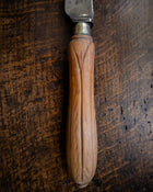Wooden-handled knife on a wooden surface