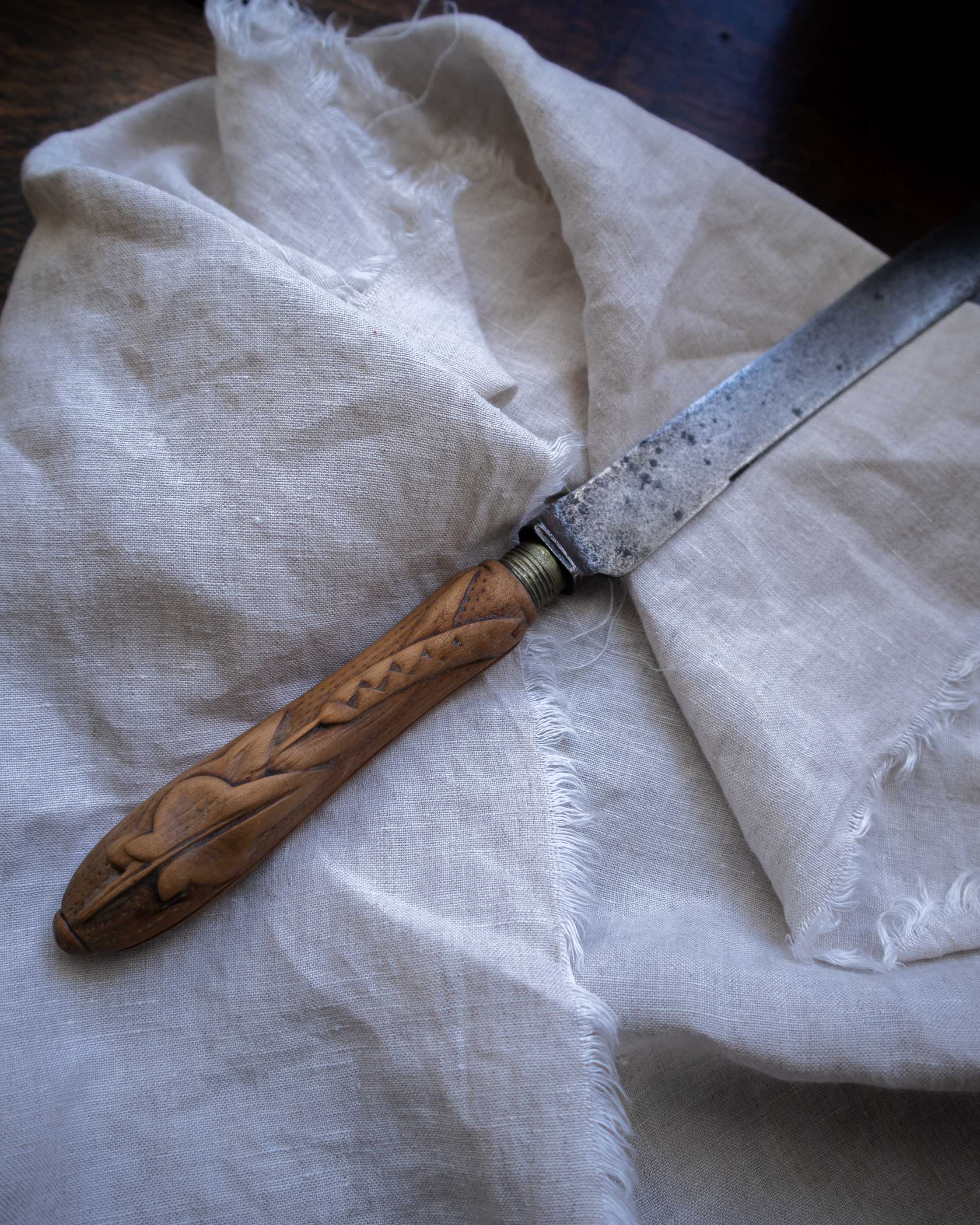 Knife with wooden handle on a white cloth