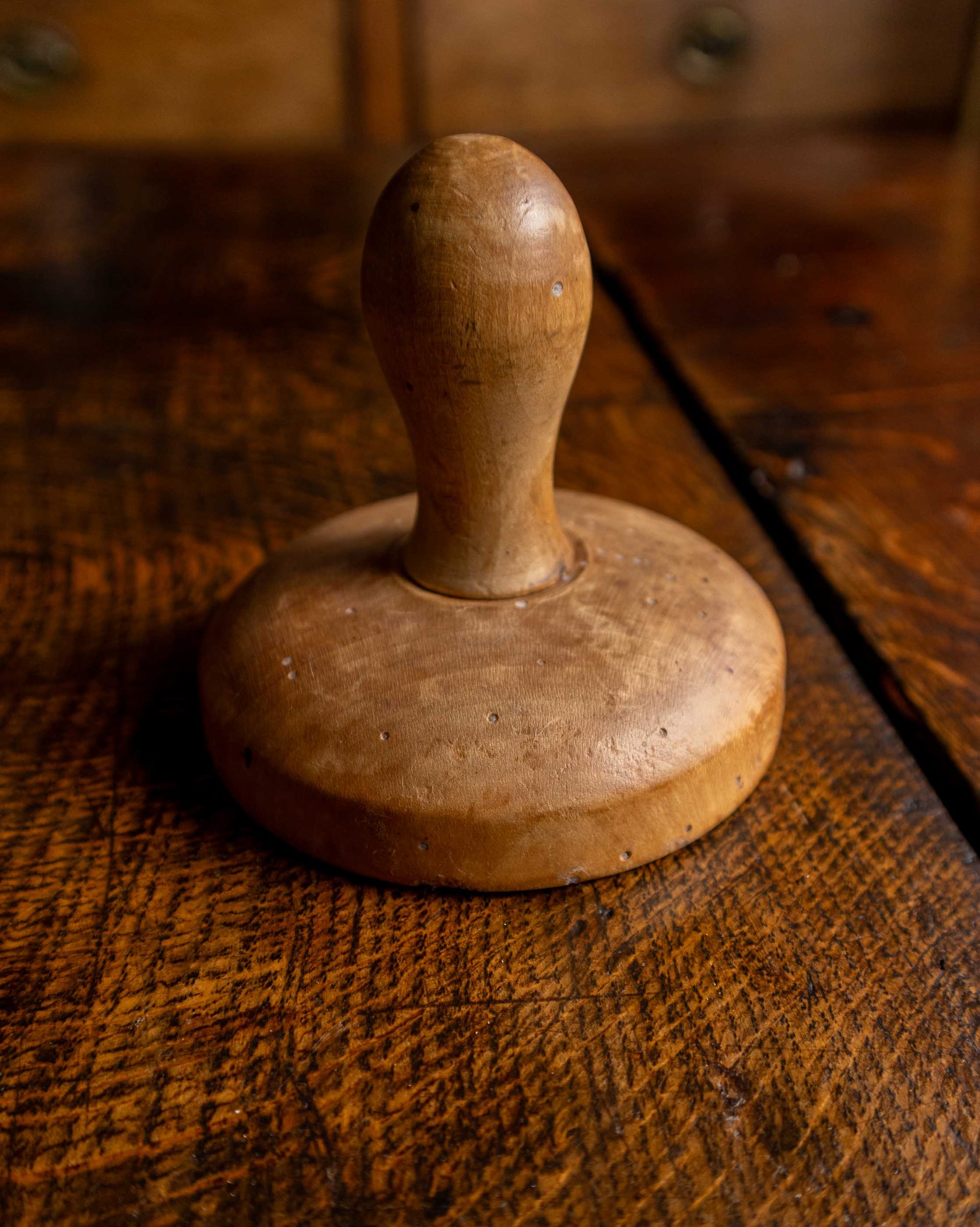 Wooden butter stamp on a rustic wooden surface