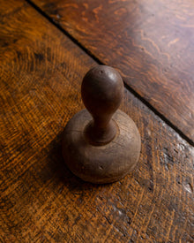 Wooden butter stamp on a wooden surface