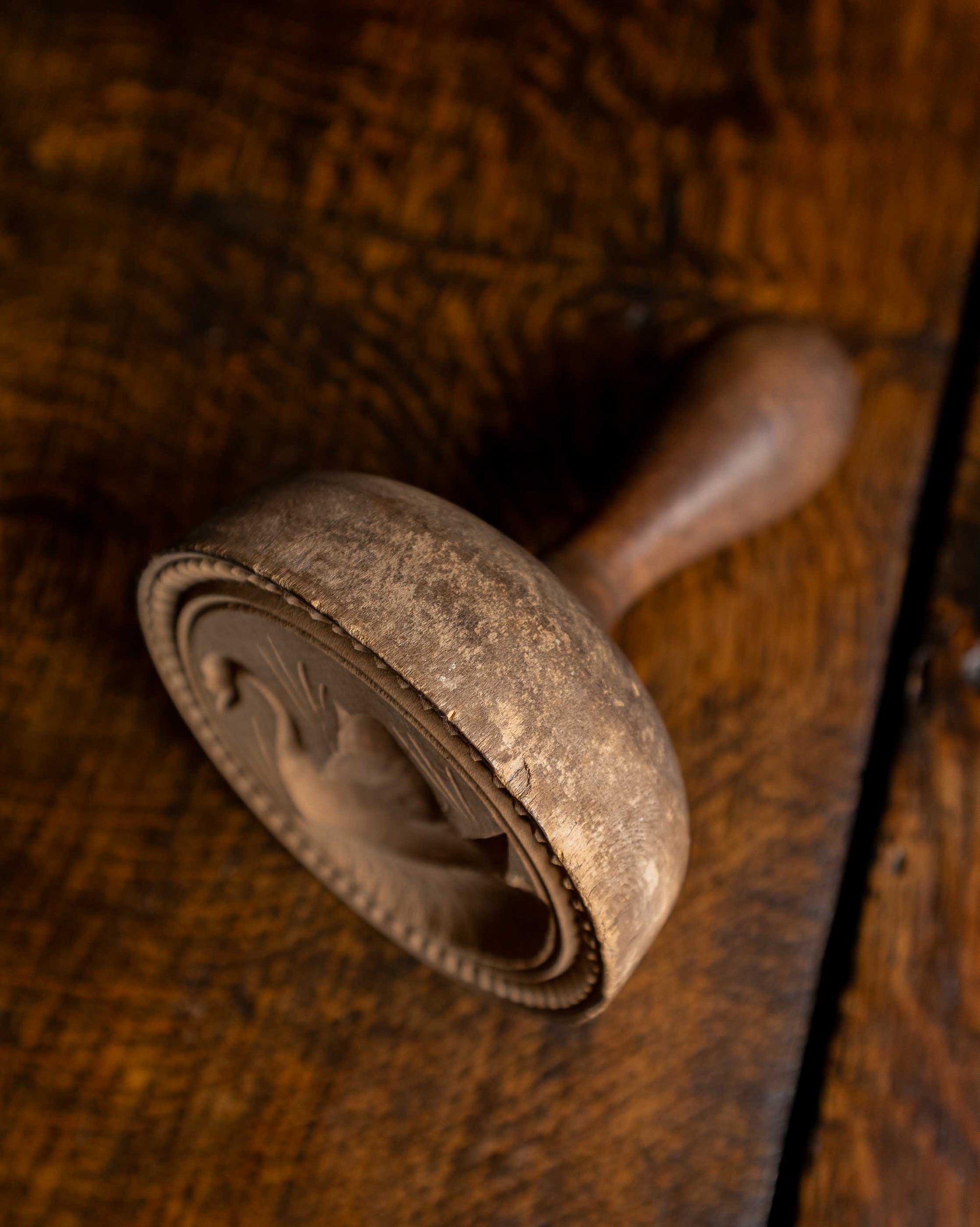 Wooden butter stamp on a wooden surface