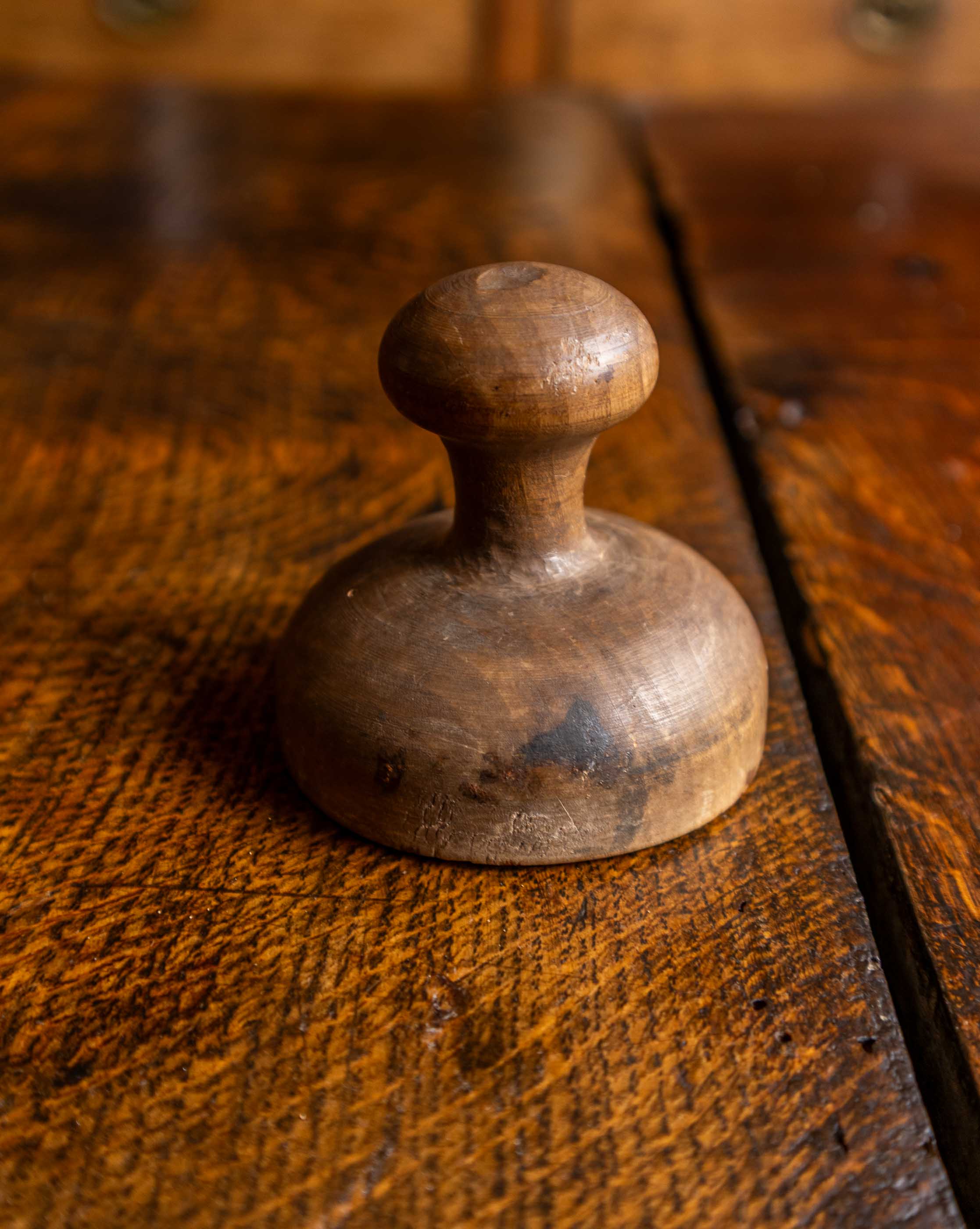 Wooden butter stamp on a rustic wooden surface