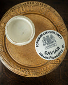 Caviar container with Fortnum & Mason label on a wooden tray