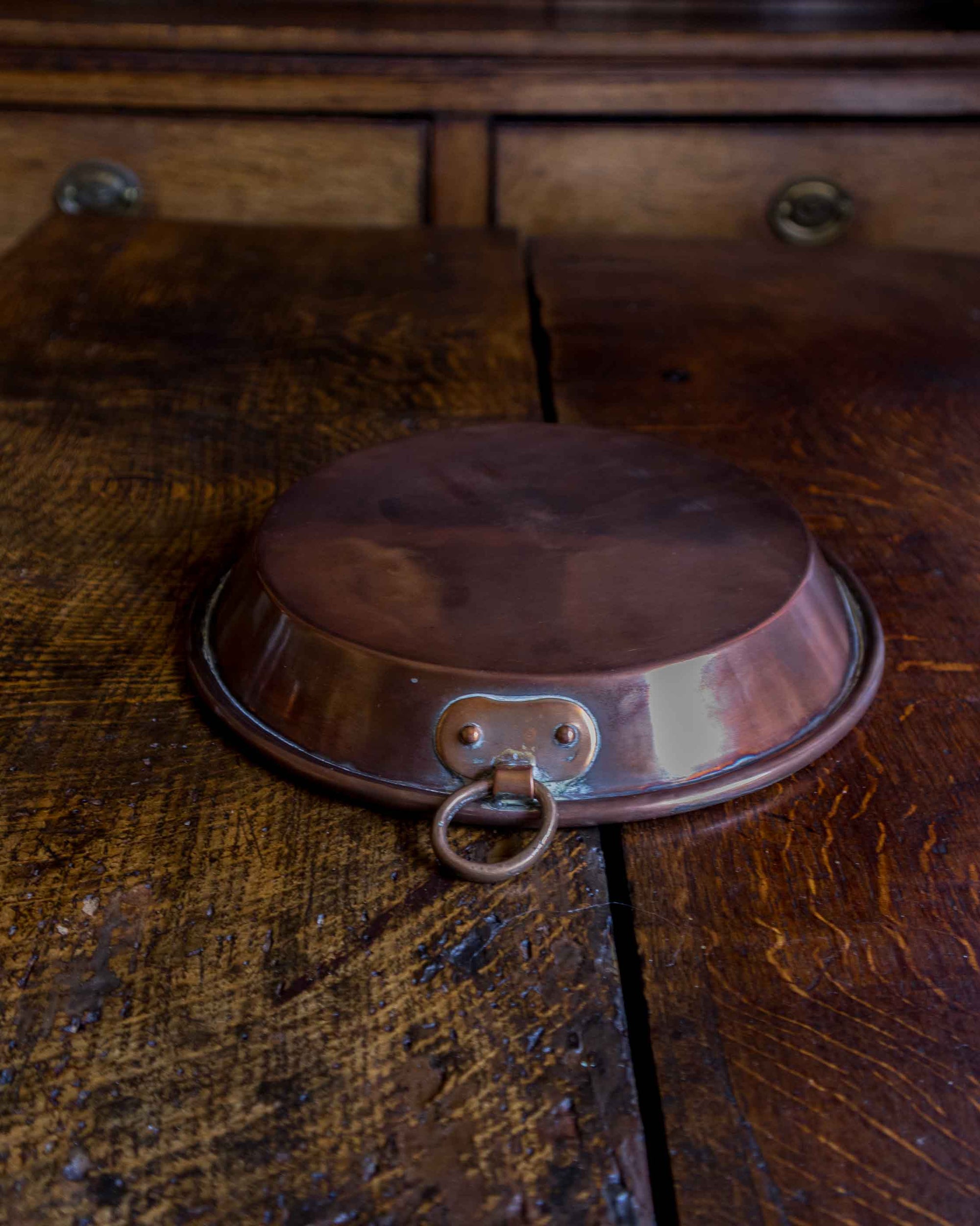 Copper dish on a wooden surface