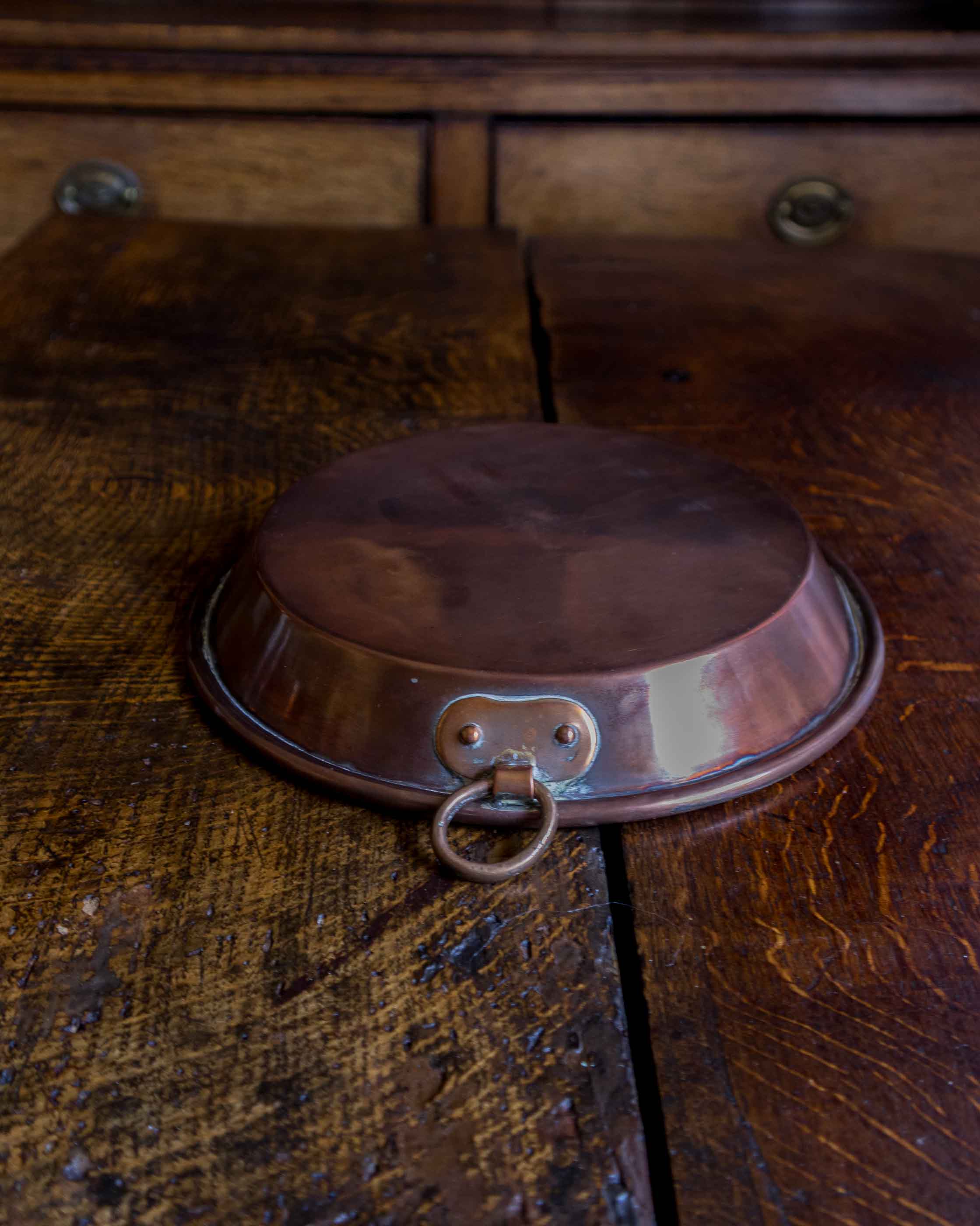 Copper dish on a wooden surface
