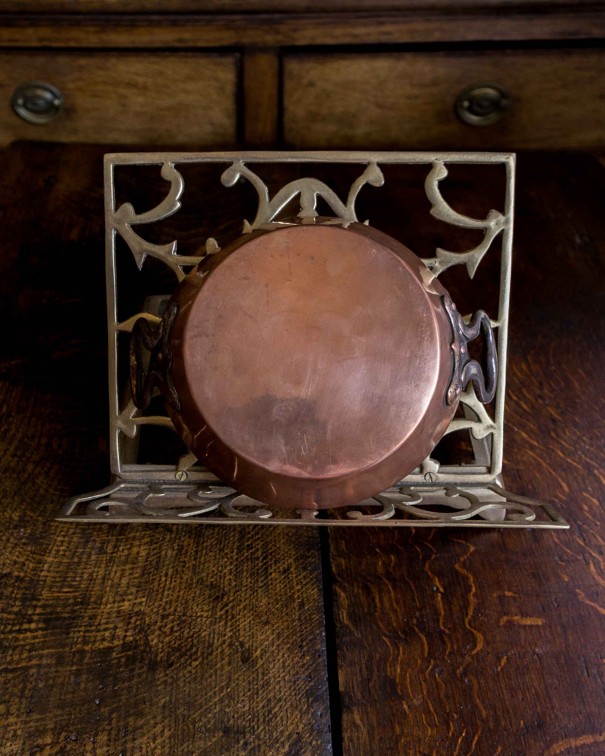 Decorative metal and copper dish on a wooden surface