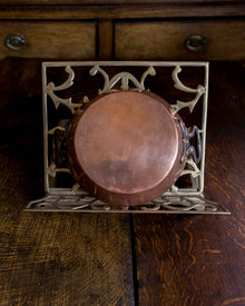 Decorative metal and copper dish on a wooden surface