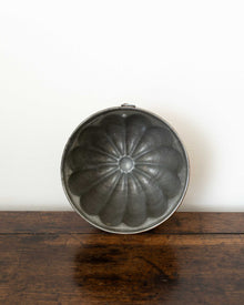 Decorative copper mould on a wooden surface