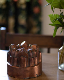 Copper mould on a wooden table with a blurred background