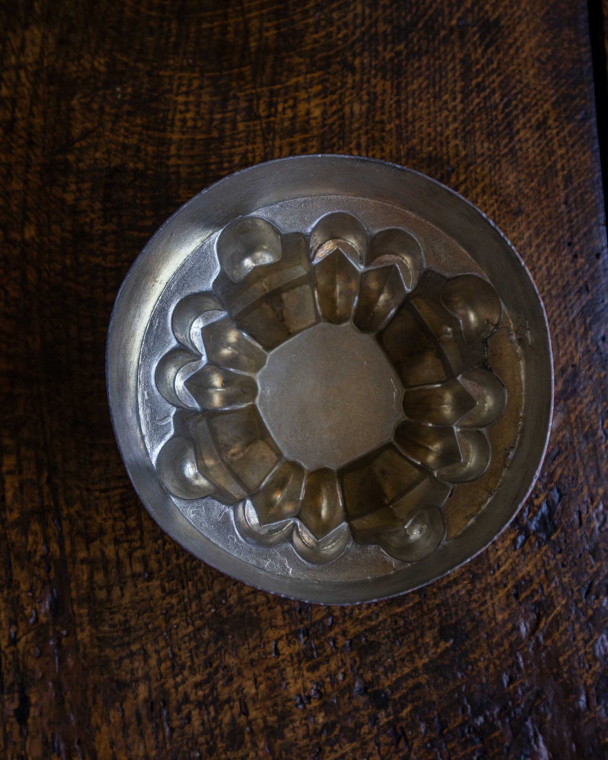 Copper jelly mould on a wooden surface