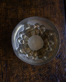Copper jelly mould on a wooden surface