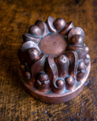 Decorative copper jelly mould on a wooden surface