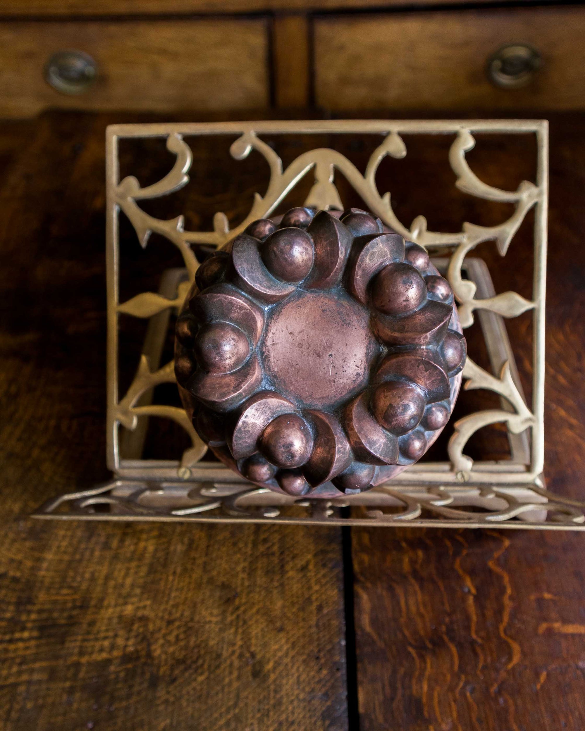 Decorative copper jelly mould on a wooden surface
