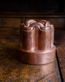 Copper mould on a wooden surface.