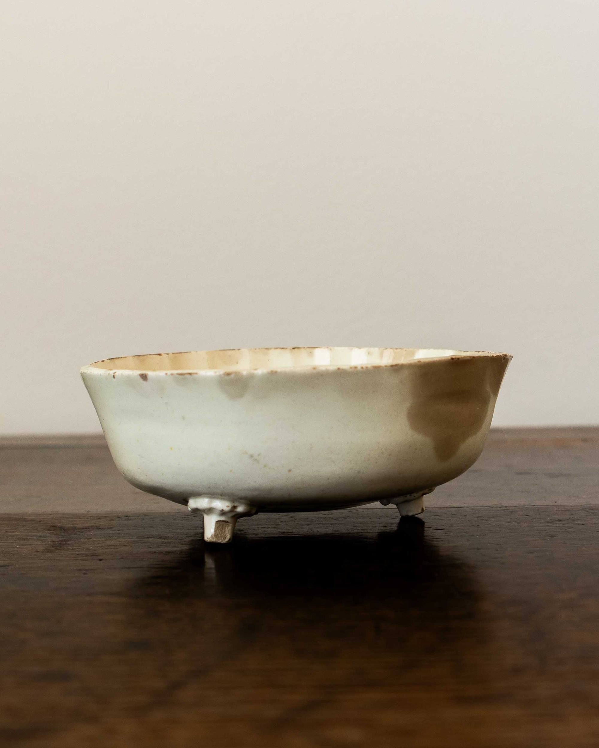 Ceramic mould on a wooden surface with a plain background