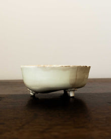 Ceramic mould on a wooden surface with a plain background
