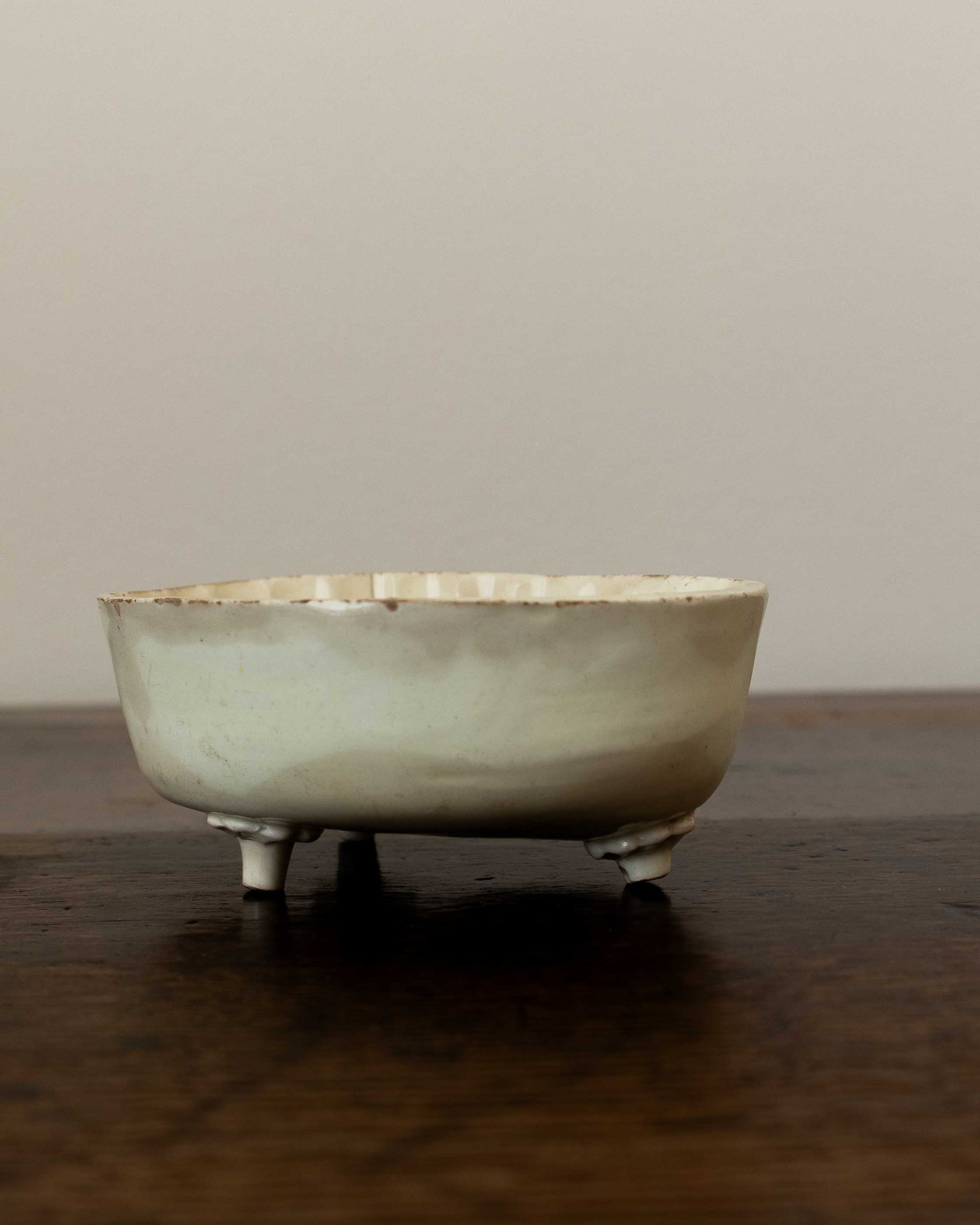 Vintage ceramic mould on a wooden surface with a plain background