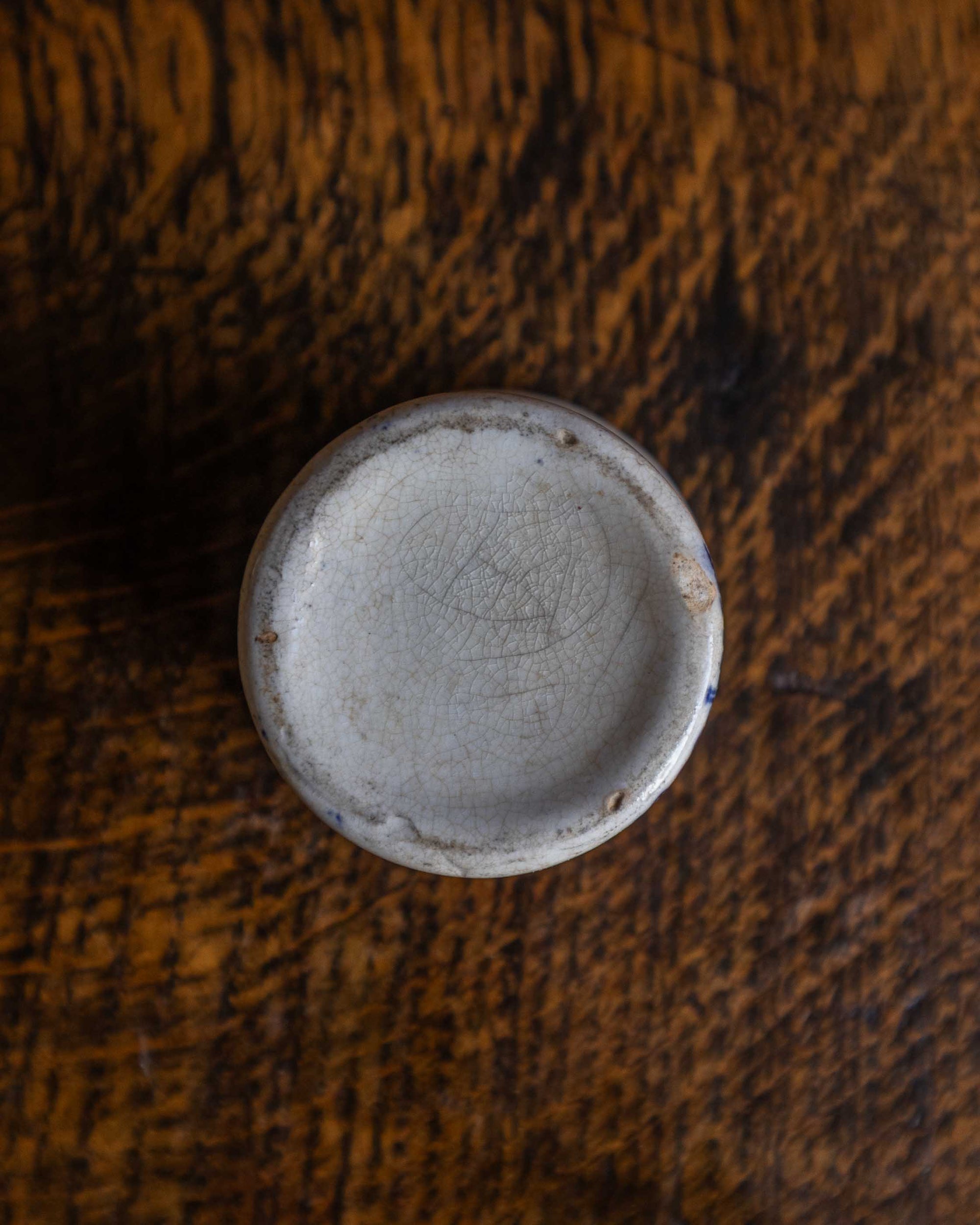 Ceramic pot base on a wooden surface