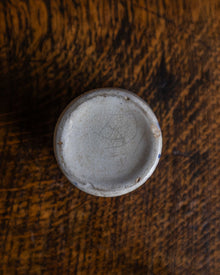 Ceramic pot base on a wooden surface