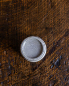 Round ceramic pot on a textured brown surface