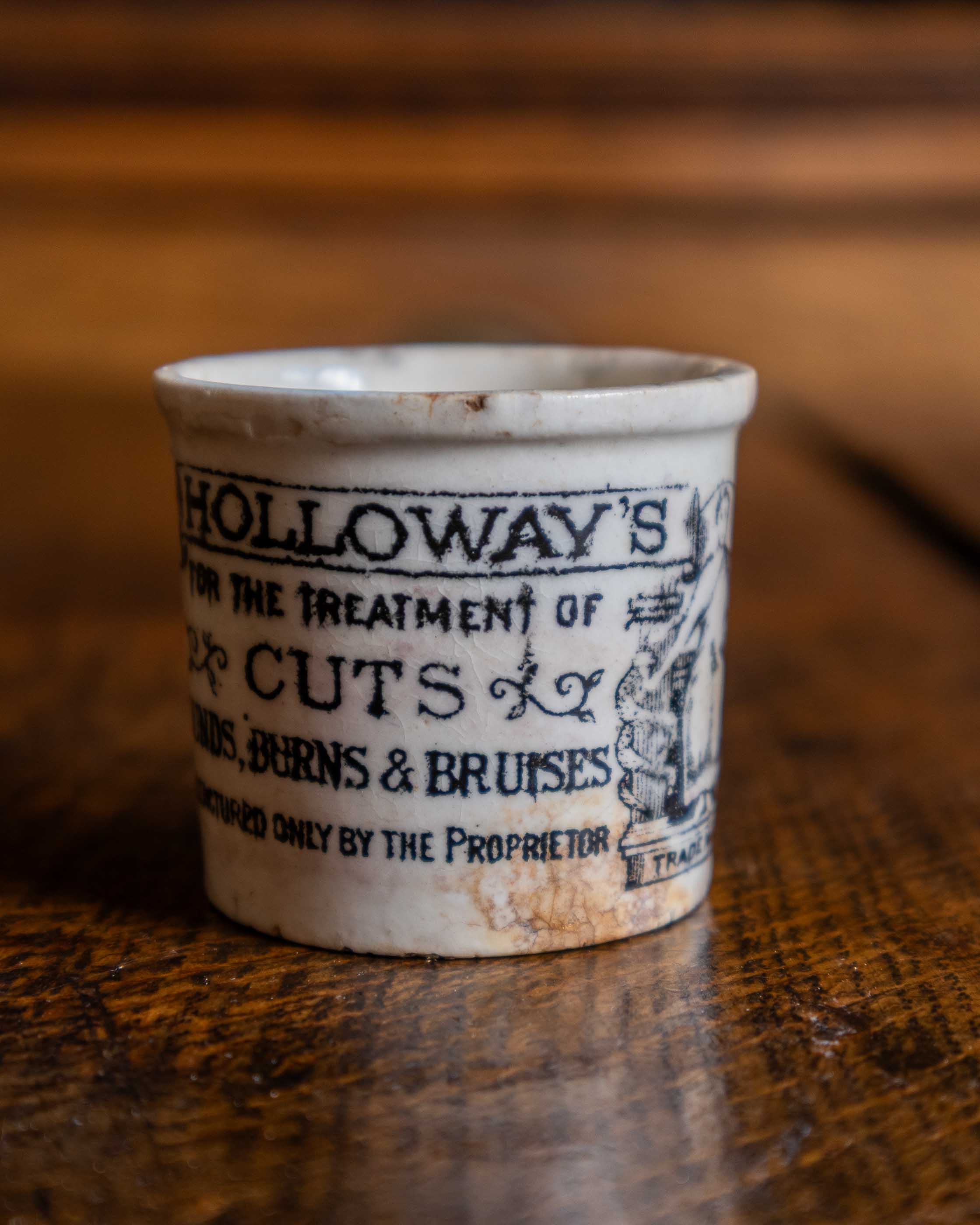 Ceramic pot with text on a wooden surface