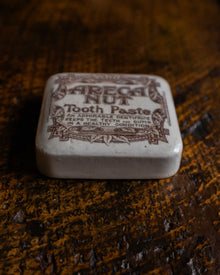 Areca Nut Tooth Paste lid on a wooden surface