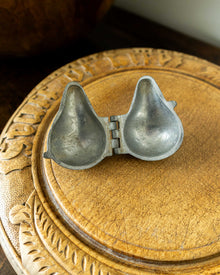 Pewter mould on a wooden surface