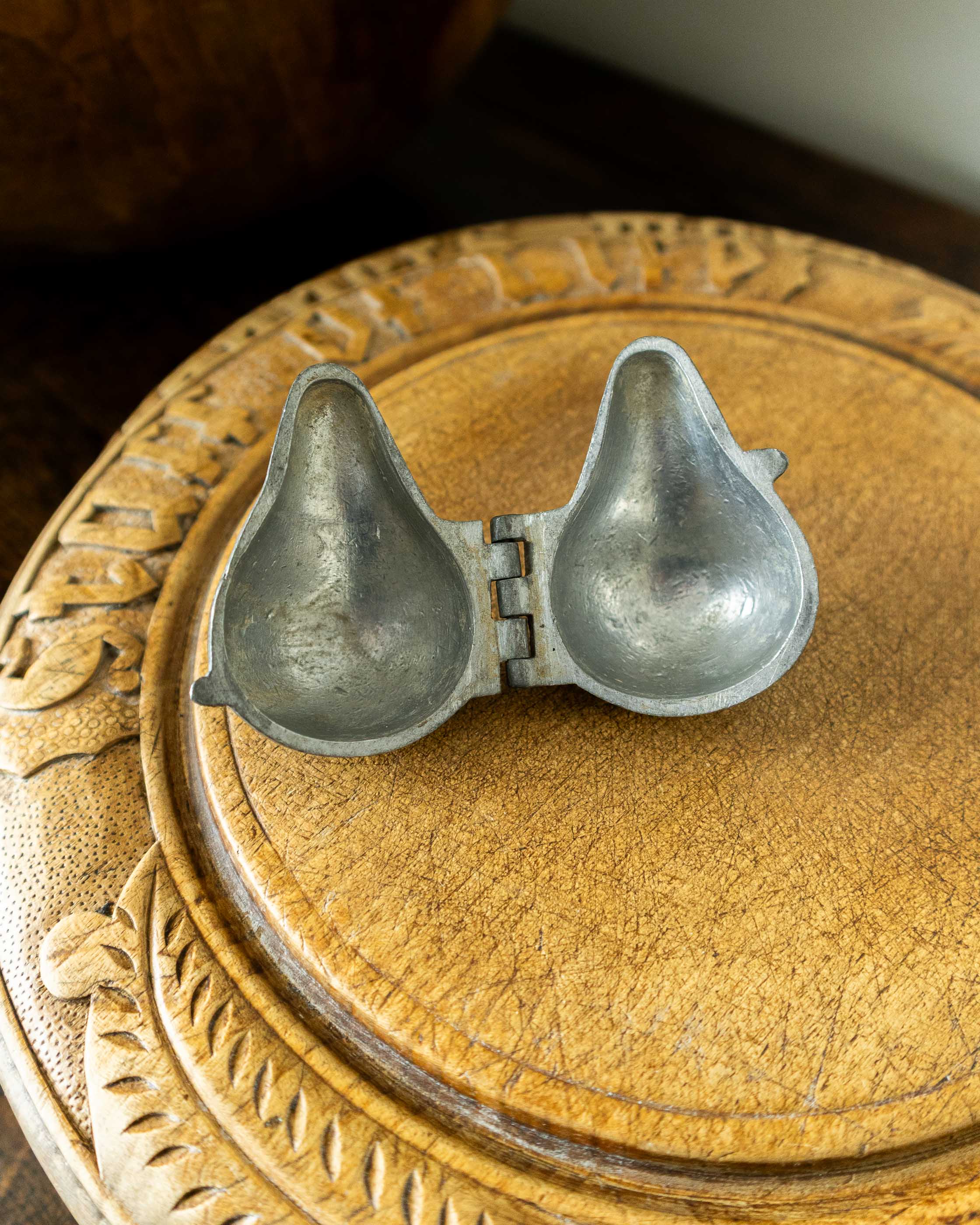 Pewter mould on a wooden surface