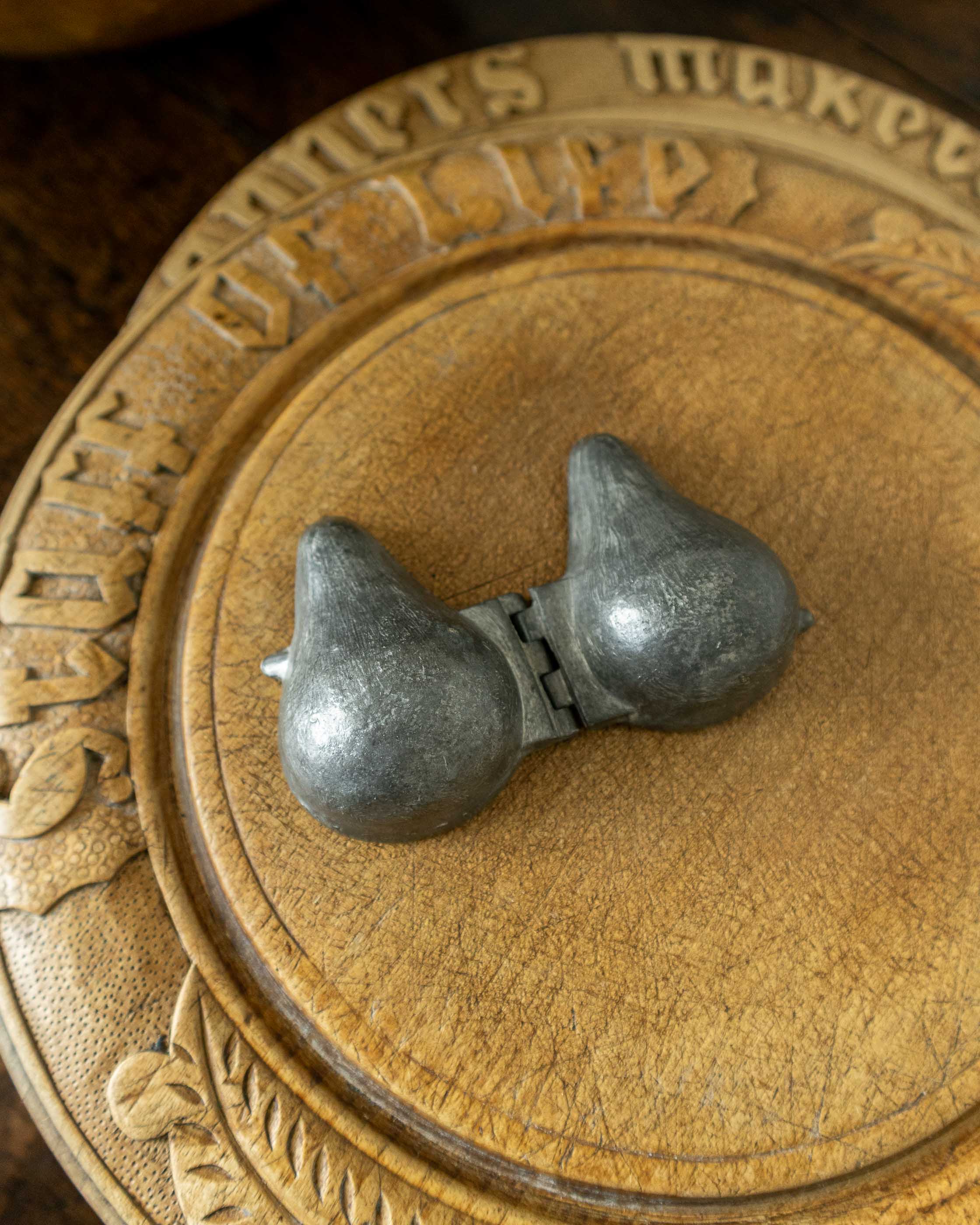 Pewter mould on a wooden surface 