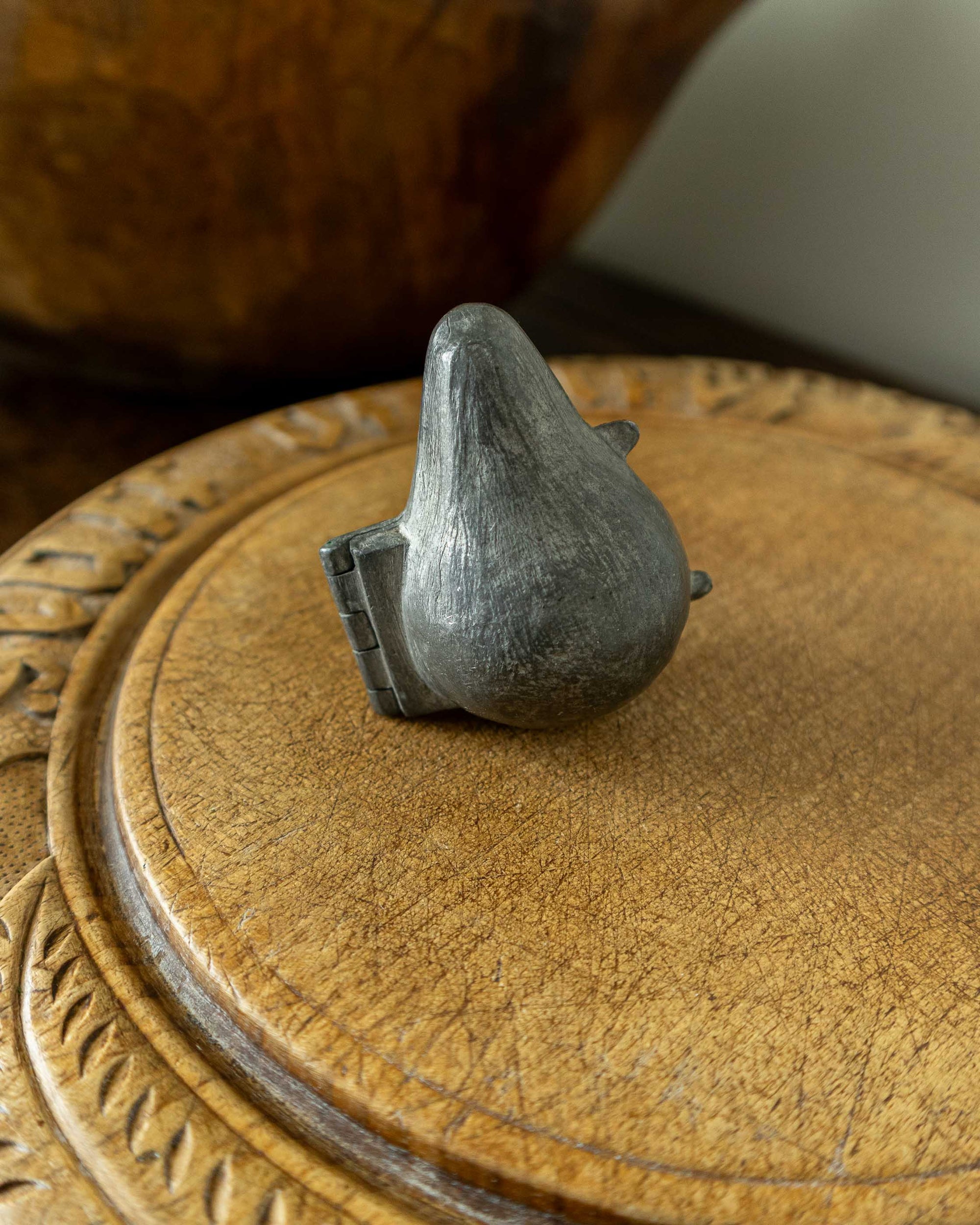 Pewter mould on a wooden surface 