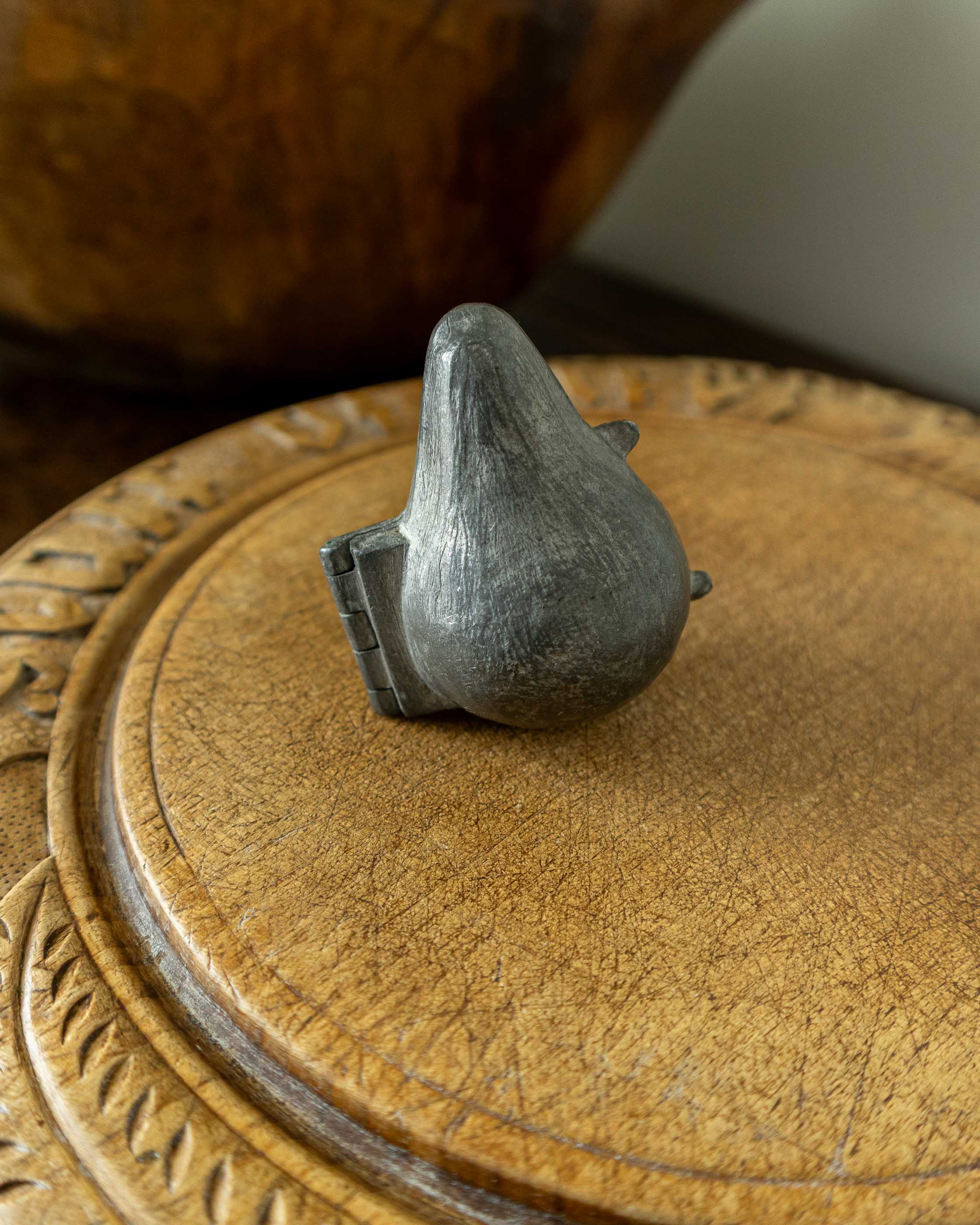 Pewter mould on a wooden surface 