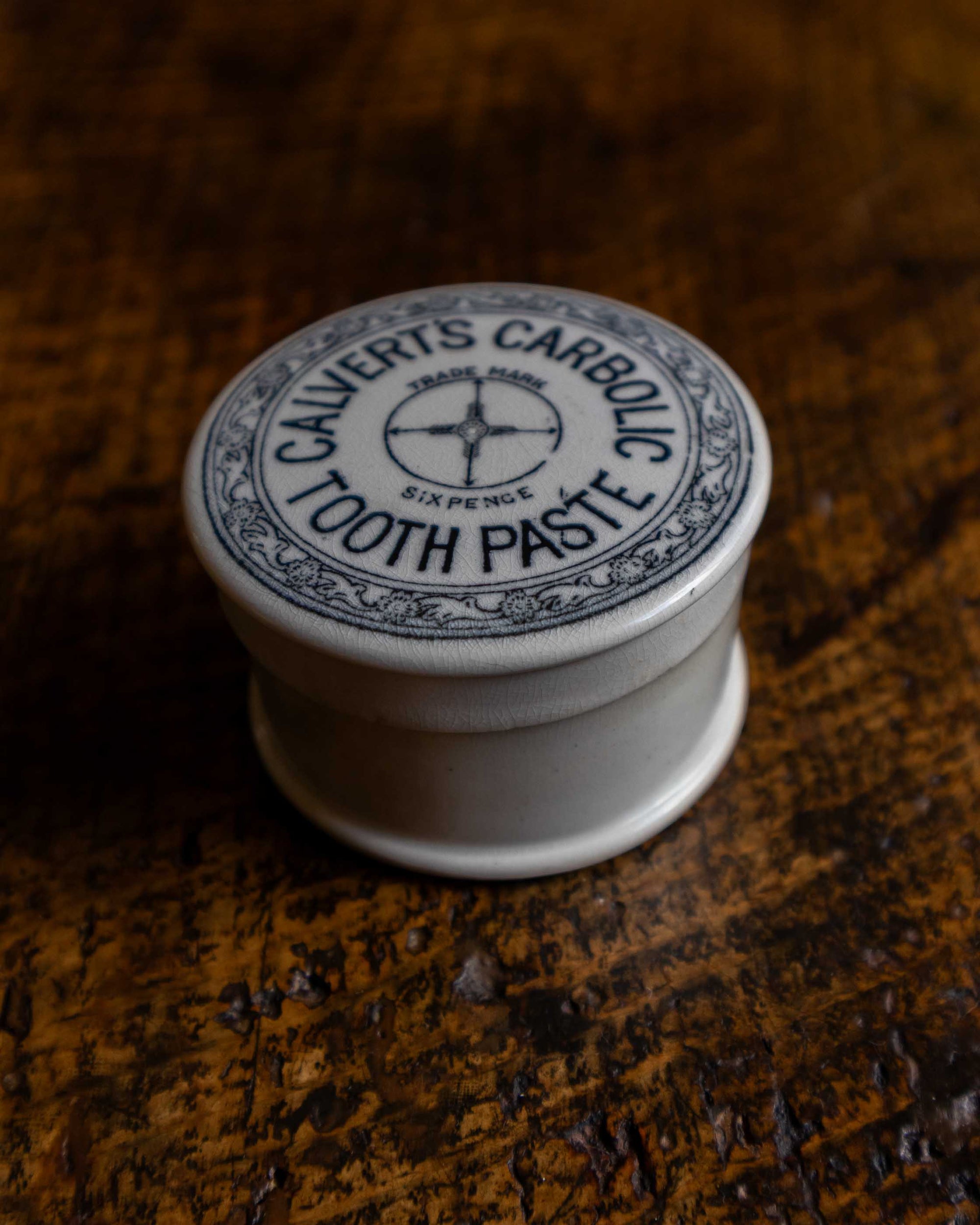 Calvert's Carbolic Tooth Paste pot on a wooden surface