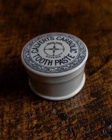 Calvert's Carbolic Tooth Paste pot on a wooden surface