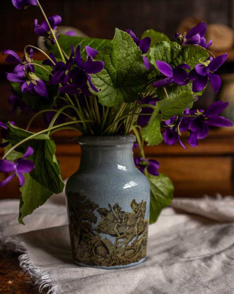 Prattware jar with purple flowers on a textured surface