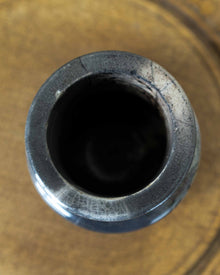 Close-up of a ceramic cylindrical jar on a wooden surface