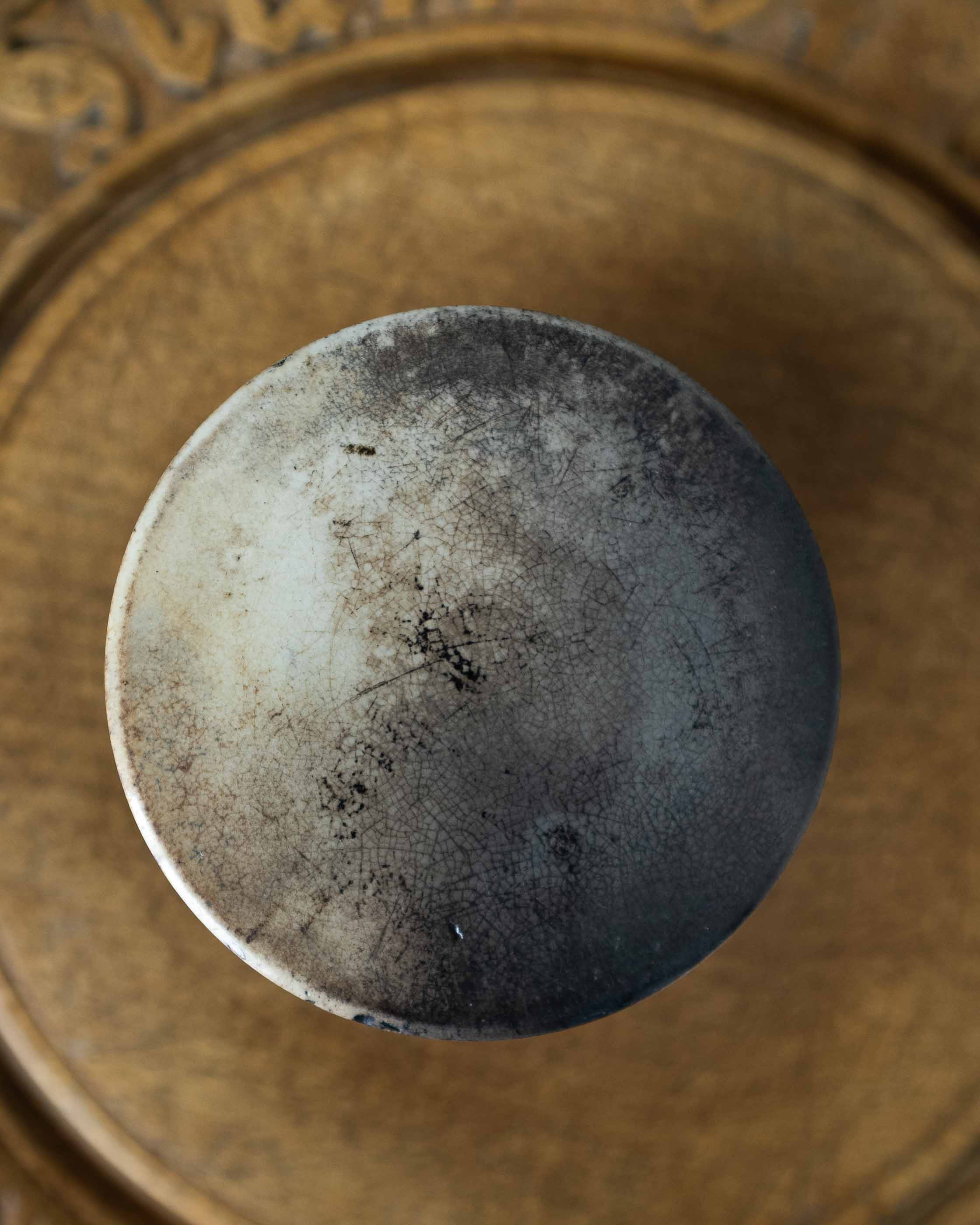 Close-up of a ceramic jar on a wooden surface