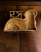 Decorative ceramic lamb mould on a wooden surface