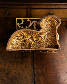 Decorative ceramic lamb mould on a wooden surface