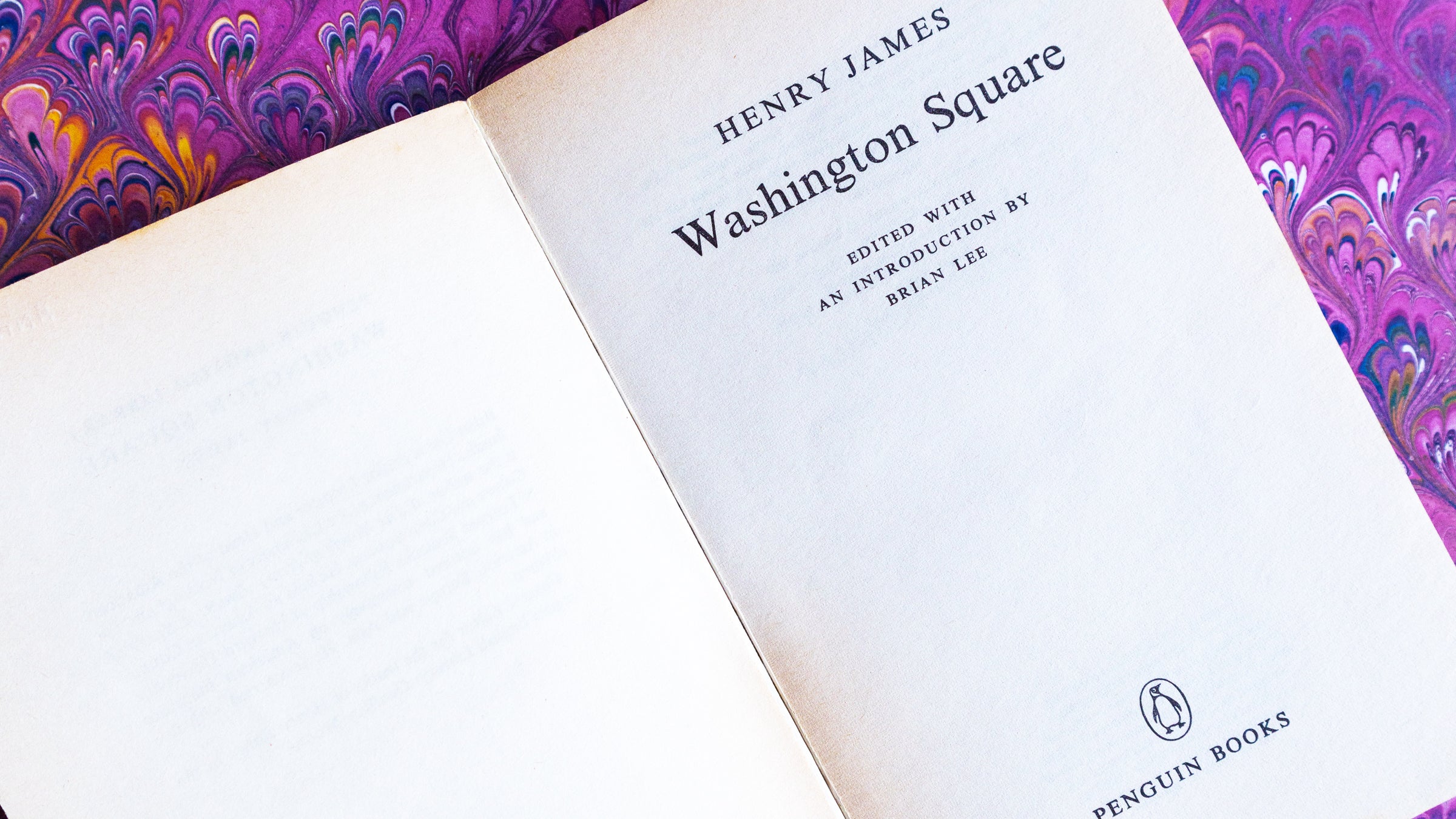 Book titled 'Washington Square' by Henry James with a marbled purple and pink cover.