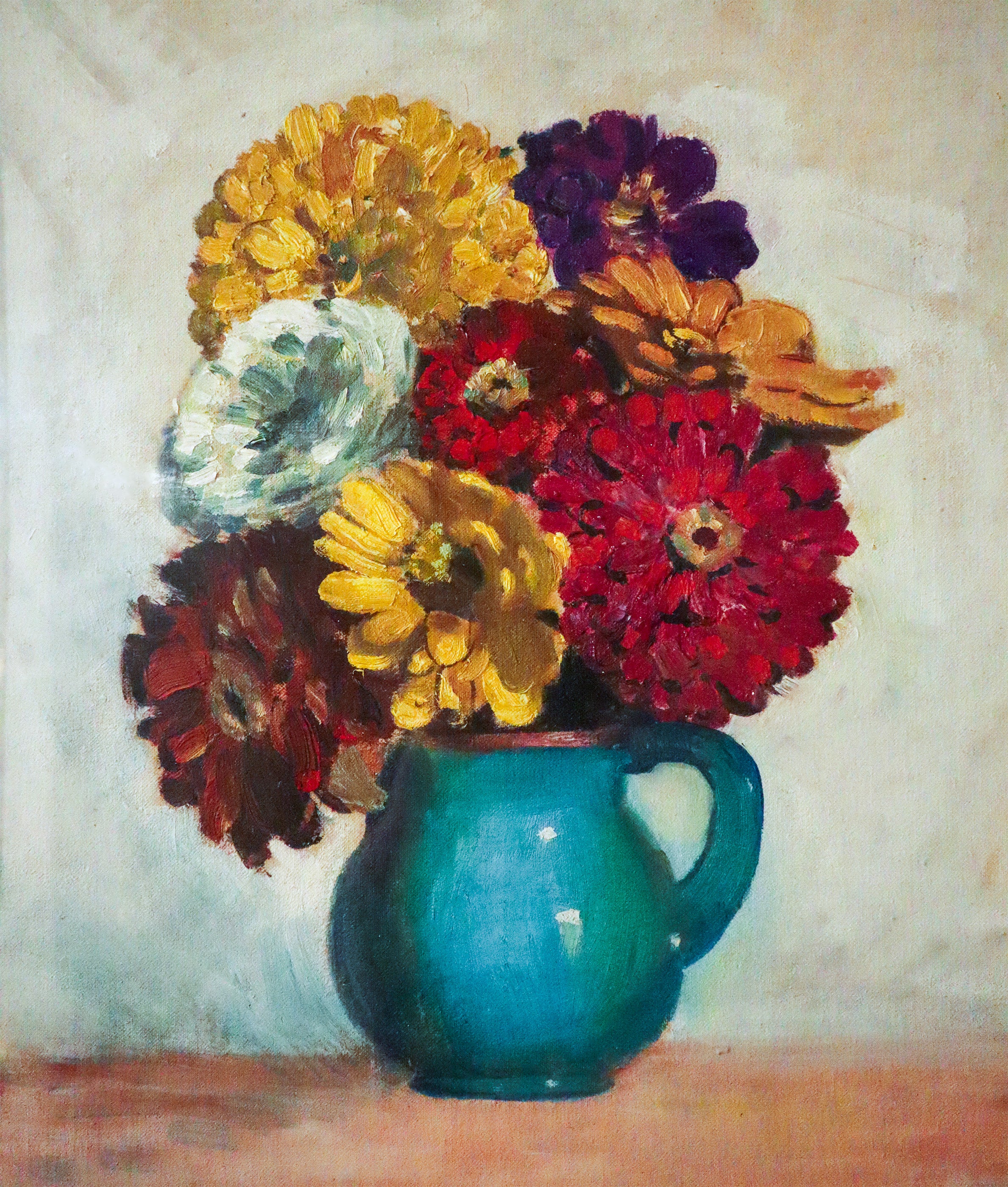 Colorful bouquet of flowers in a blue vase on a textured surface