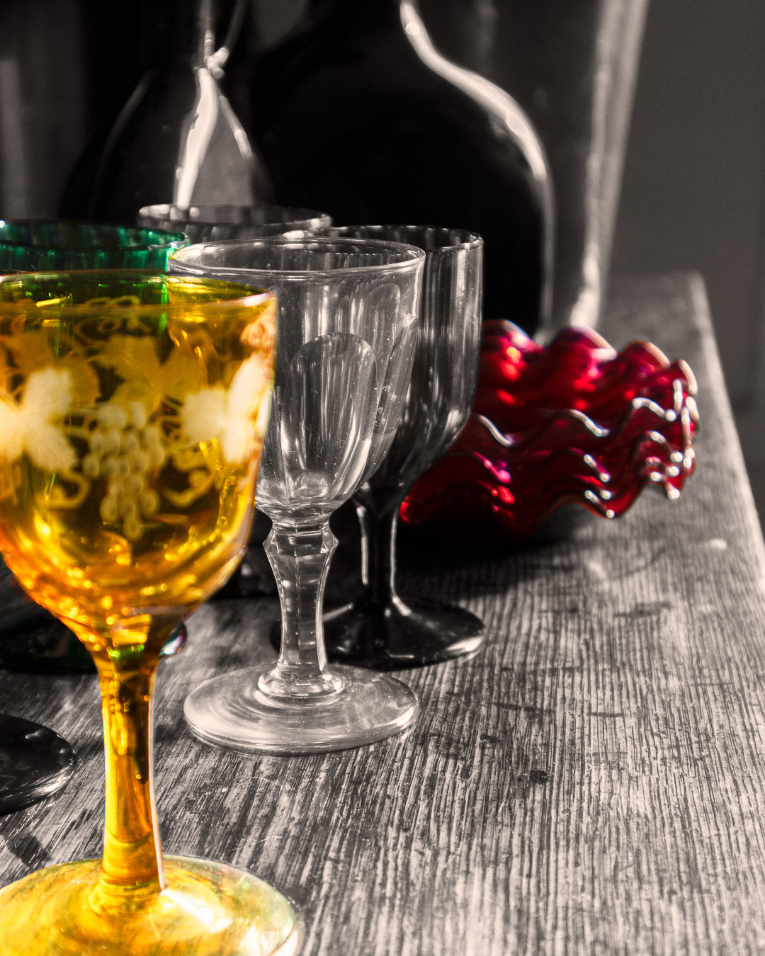 Collection of coloured glasses on a black and white background