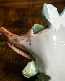 Close-up of a ceramic object with a textured surface on a wooden background