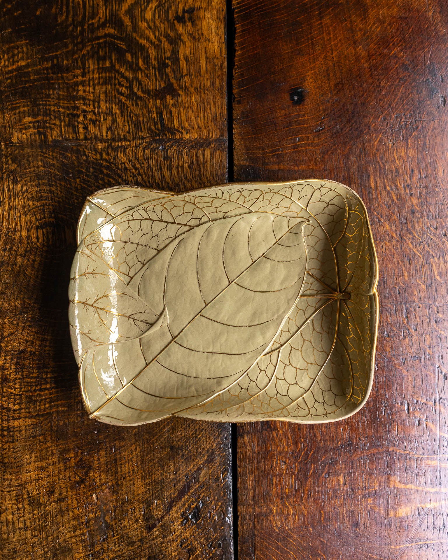 Leaf-shaped Wedgwood ceramic dish on a wooden surface