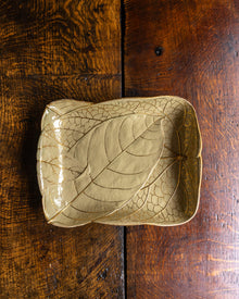 Leaf-shaped Wedgwood ceramic dish on a wooden surface