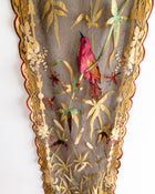Decorative panel with embroidered red bird and floral patterns on a textured background