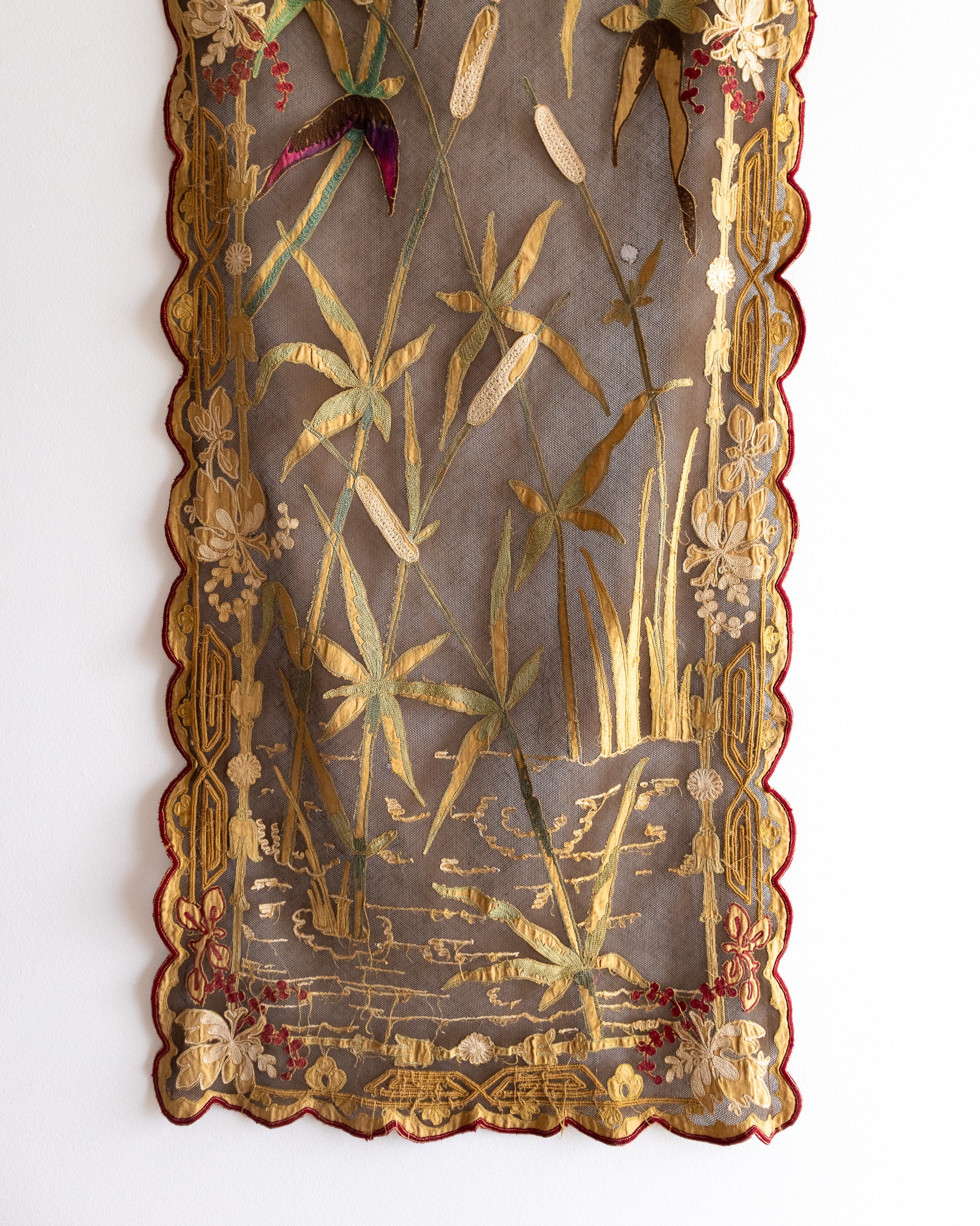 Decorative panel with embroidered floral and botanical patterns on a white background