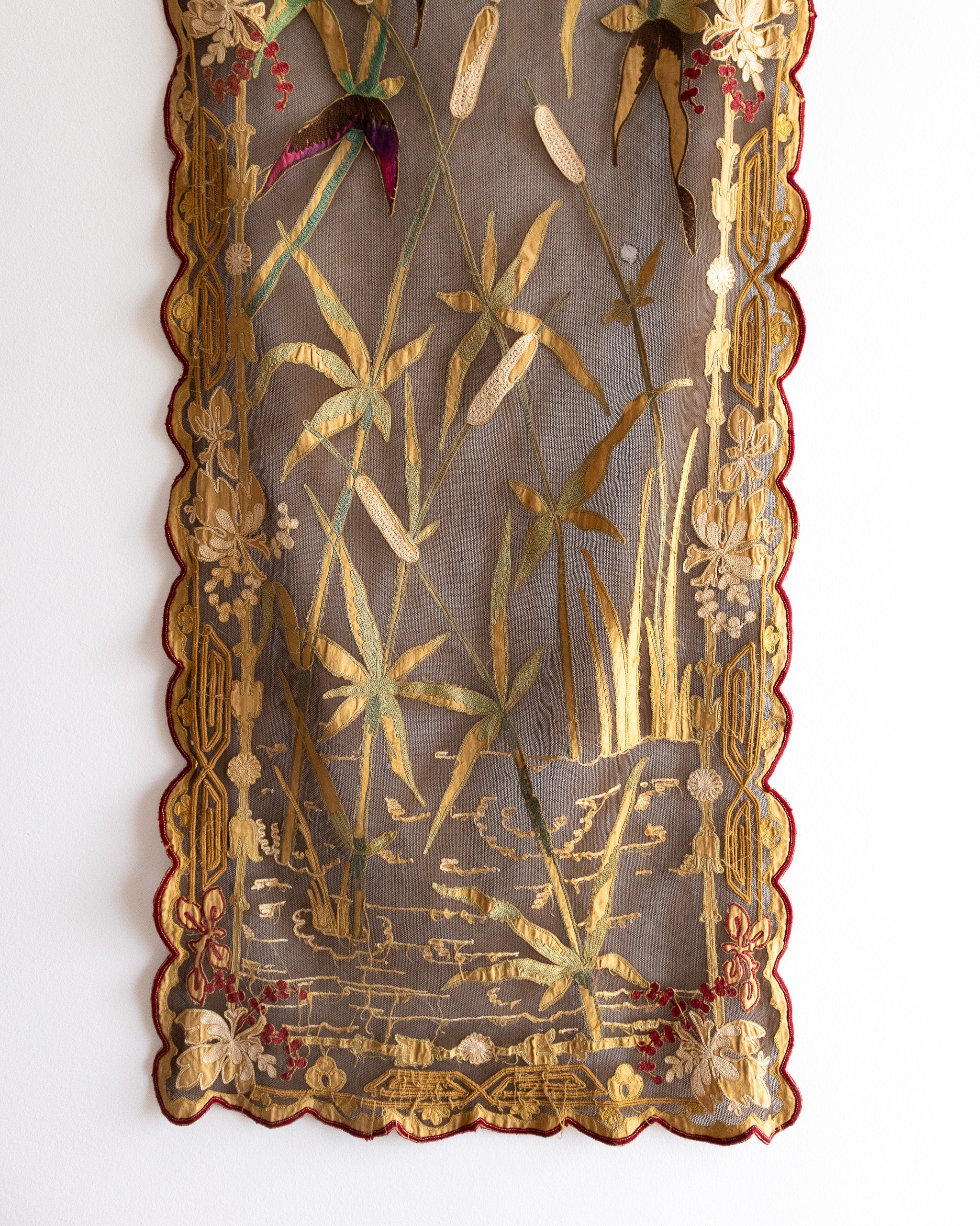 Decorative panel with embroidered floral and botanical patterns on a white background