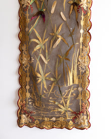 Decorative panel with embroidered floral and botanical patterns on a white background